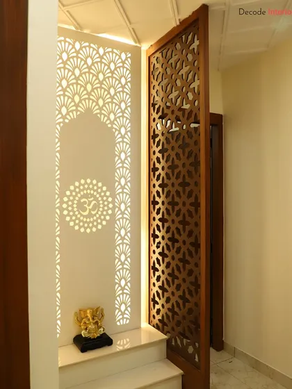 We design sacred spaces that blend tradition with modern aesthetics. This compact mandir features an intricate backlit 'Om' panel and a wooden jali door, creating a peaceful corner for prayer and reflection within the home.