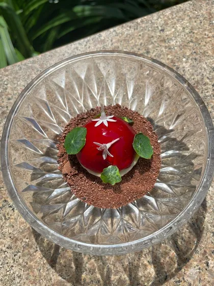 The Goose Liver Bonbon in natural light, highlighting the glossy cherry glaze.