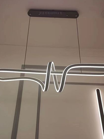 An abstract, ribbon-like linear pendant. This fixture is a true conversation starter, perfect for a modern and artistic home.