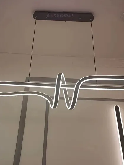 An abstract, ribbon-like linear pendant. This fixture is a true conversation starter, perfect for a modern and artistic home.