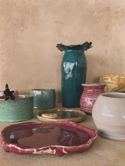 A collection of finished, glazed pieces, including plates, vases, and bowls, ready to be used and loved.