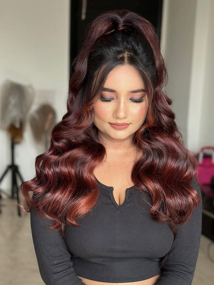 The same top knot waves style, showing how it looks from the front. The red hair color adds a bold and beautiful touch.