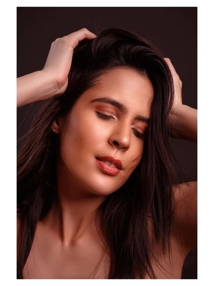 A close-up beauty portrait with a sensual and dreamy feel. The soft lighting and the model's expression create an intimate and captivating mood.