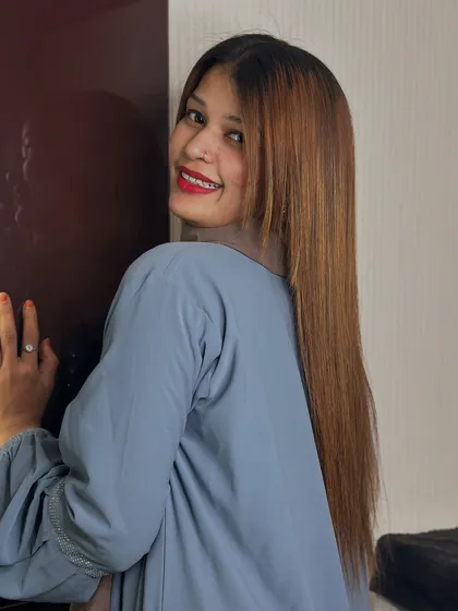 A happy client showing off her smooth, straight hair after a Botox treatment.