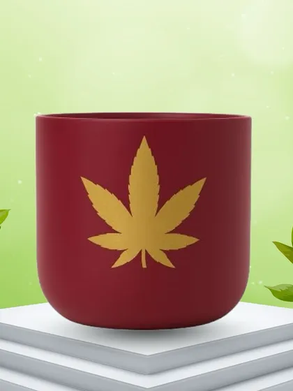 A clean product shot of the red terracotta planter with the golden leaf motif. This view highlights the vibrant color and the detailed design of the pot itself.