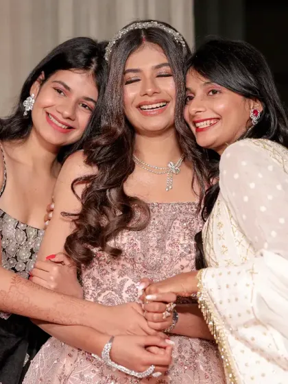 A heartwarming, candid moment of the bride sharing a hug and a laugh with her friends or sisters. These are the memories that last a lifetime.