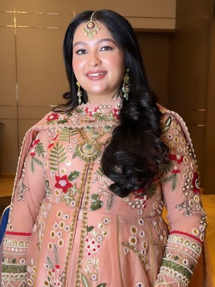 The final result is a happy bride who looks and feels like herself, just a little extra special for her big day. The soft makeup is the perfect complement to her detailed outfit.