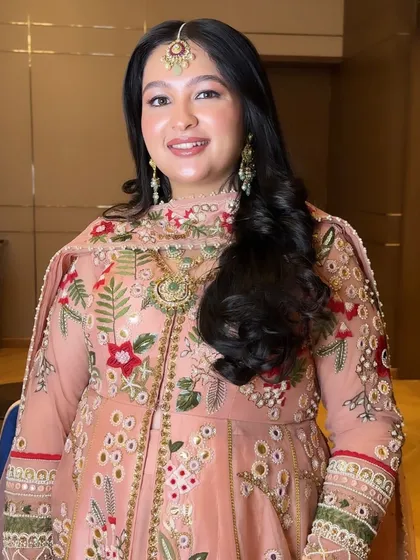 The final result is a happy bride who looks and feels like herself, just a little extra special for her big day. The soft makeup is the perfect complement to her detailed outfit.