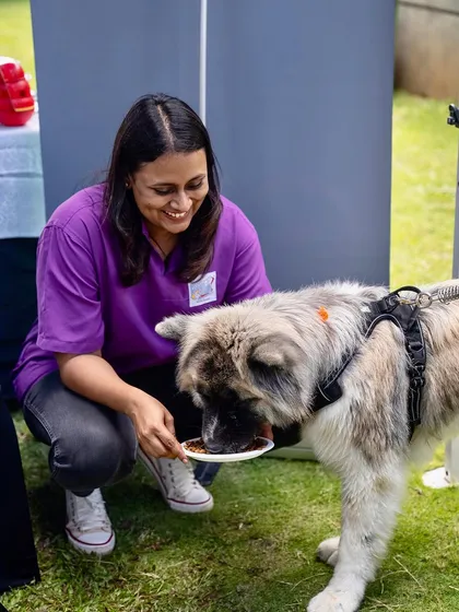 Sharing a moment of joy and a tasty meal with a furry friend.
