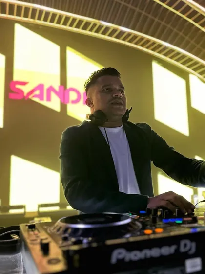 In the zone during a destination wedding in Vietnam. This shot captures my focus at the Pioneer DJ console, with my name lit up in the background, showcasing the professionalism I bring to every international gig.