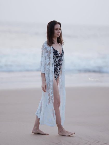 A walking shot along the beach, creating a sense of movement and narrative. This is a great way to add a lifestyle feel to a fashion shoot.