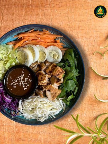 My Fortune Bowl is designed to bring you good health and good luck. It's a colorful assembly of grilled chicken, boiled eggs, fresh greens, and a savory dressing.