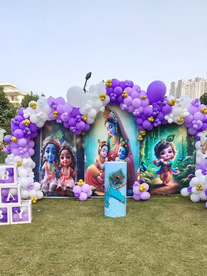The complete backdrop and balloon arch for the beautiful outdoor Krishna-themed celebration.