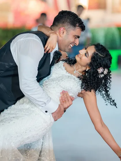 A magical first dance. For this curly-haired bride, I created a look that was both romantic and durable, ensuring her curls and makeup stayed perfect all night.