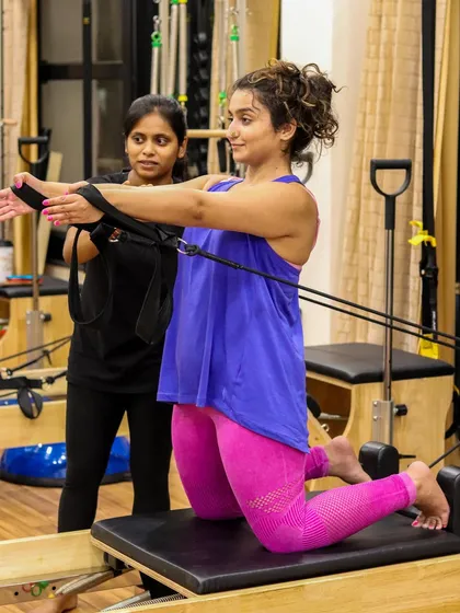 Our trainer provides support and guidance as a client works on her upper body and core strength. This attentive coaching helps build confidence and ensures every exercise is performed with perfect technique.