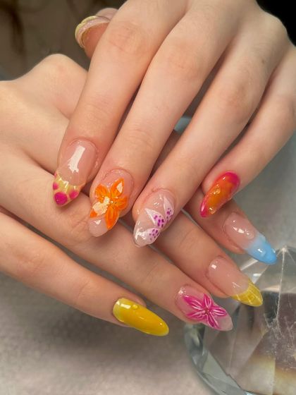 A full view of the summer-themed nail art, with its mix of colorful French tips, ombré, and hand-sculpted 3D flowers.