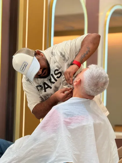 We believe grey hairs are highlights of wisdom. Our stylist provides a careful beard trim for a distinguished gentleman, ensuring a neat and respectable look.