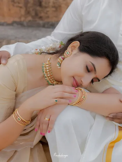 A close-up shot focusing on the bride-to-be's peaceful expression as she rests on her partner's lap.