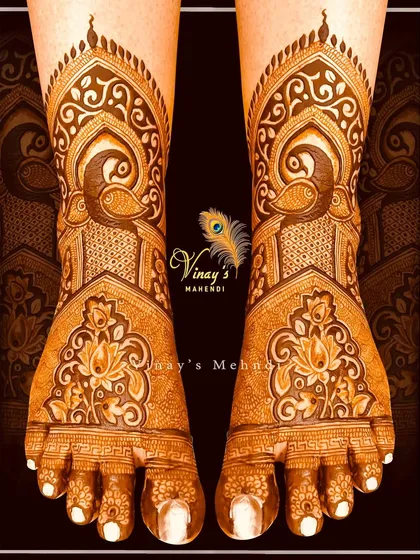 An elegant bridal foot design with peacocks and lotus motifs. The pattern flows beautifully from the ankle to the toes, creating a graceful and elongated look.