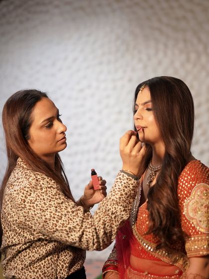 A behind-the-scenes shot of me working on my beautiful bride, Ekta. This is where the magic begins, with careful application and attention to every detail.