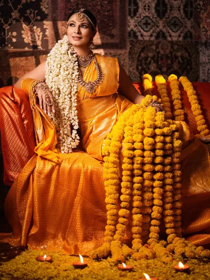 A wide shot capturing the full, majestic scene. Tanishaa is depicted as a goddess on her throne, embodying power and grace in this meticulously styled traditional look.
