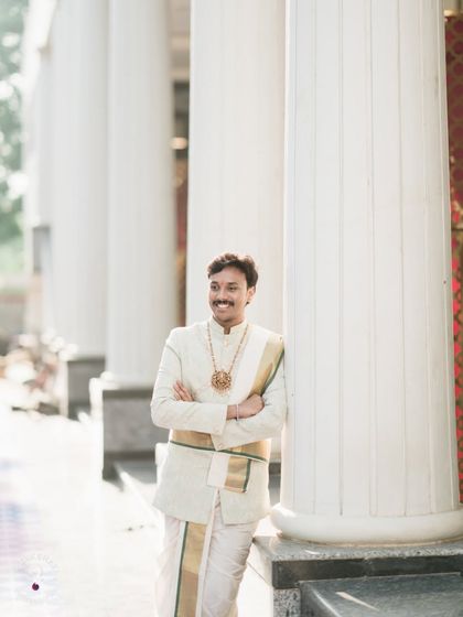 A classic portrait of the groom in his traditional veshti and sherwani, looking regal.
