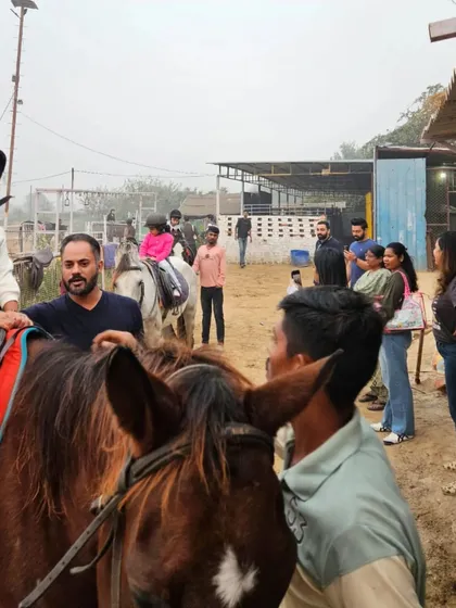 A trainer offers guidance to a young girl on her horse. Individual attention is key to our teaching approach.