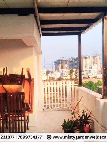 The view from the newly installed puff sheet pergola, showing how it creates a functional and protected balcony space with a great view of the city.