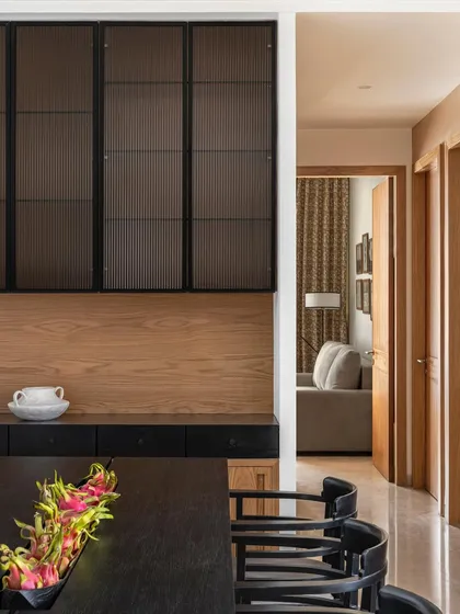 The dining area in Apartment 3201 showcases our focus on clean lines and minimal details. A sleek black dining table is complemented by a custom sideboard with fluted glass, creating a sophisticated space that is both functional and beautiful.