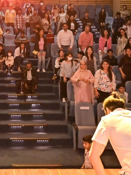 The view from the stage is always the best. Here I am, interacting with the proud parents and families who make up our amazing support system. Their cheers make all the difference.
