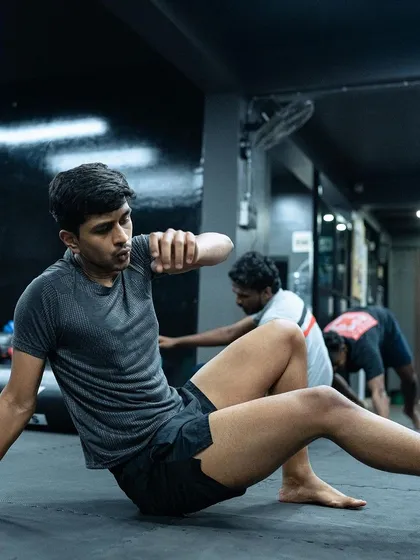A student practices his ground movement, an essential drill for improving mobility in grappling.