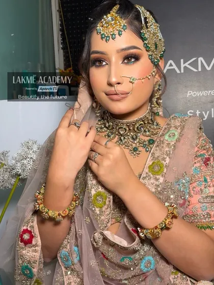 Mastering the art of bridal makeup is a cornerstone of our curriculum. This image showcases a complete bridal look created by our students, focusing on flawless base application, intricate eye makeup, and perfect accessorizing.