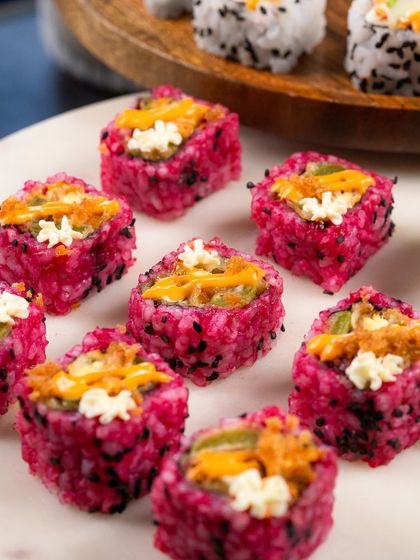 A close-up shot of the Pink Rice Assorted Tempura rolls, showing the beautiful colour and texture.