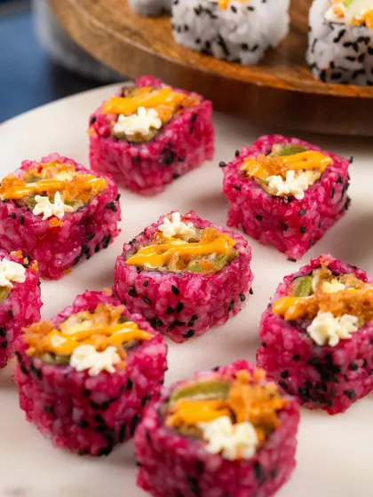A close-up shot of the Pink Rice Assorted Tempura rolls, showing the beautiful colour and texture.