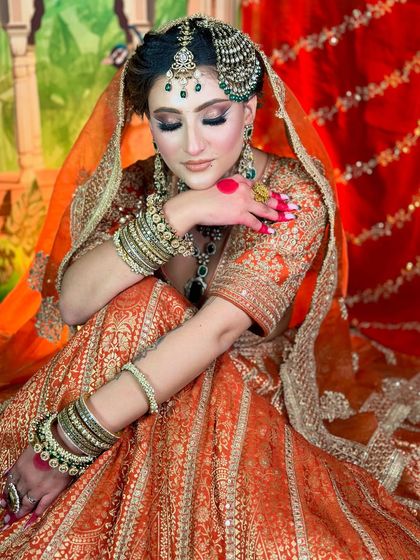 A candid, relaxed pose. The makeup looks flawless even in softer, more natural lighting.