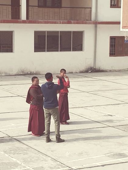 A moment of instruction and demonstration during our session at the monastery. The focus and discipline they brought from their daily lives translated beautifully to the basketball court.