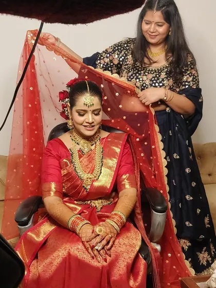 A behind-the-scenes moment of me setting the dupatta for my South Indian bride.