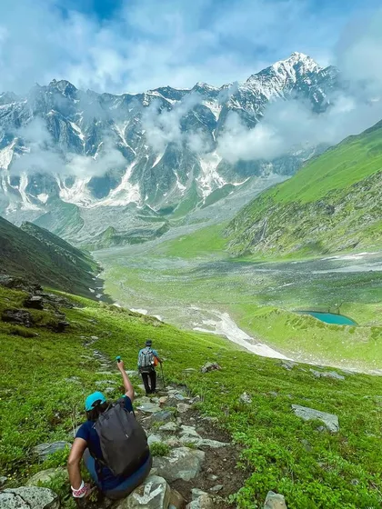 The Beas Kund trek offers some of the most dramatic alpine scenery. You walk through lush green valleys with massive, snow-capped peaks like Hanuman Tibba right in front of you.