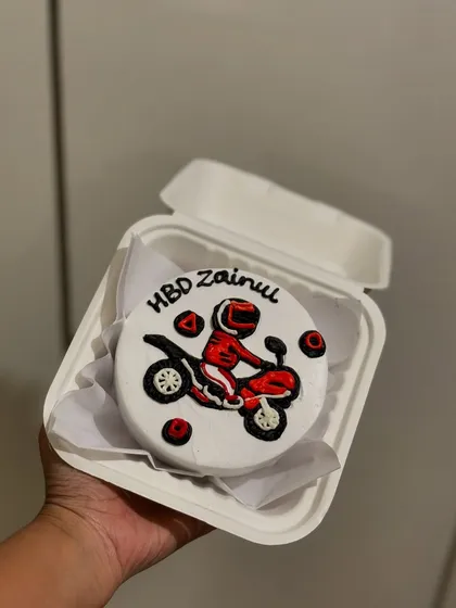 A bento cake for a biker, with a motorcycle hand-piped in detail. A great example of a personalized hobby-themed cake.