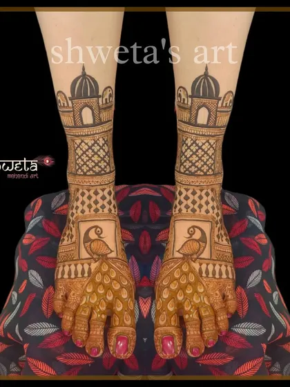 A classic bridal leg design with peacock and palace motifs. The pattern is clean and symmetrical, providing an elegant and traditional look that matches any bridal hand mehendi.