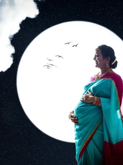 A serene solo maternity silhouette. The expecting mother gazes out peacefully against the moon, creating a powerful and contemplative portrait.