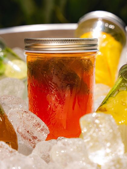 A close-up of our iced tea, steeped with fresh herbs and served ice-cold. It's the perfect refreshing drink to accompany a hot pizza.