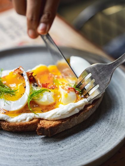 The moment of truth: cutting into our Turkish Toast to reveal the soft-boiled egg and creamy yogurt spread.