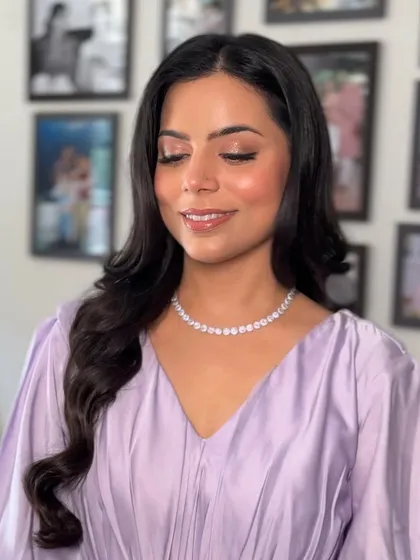 Here is the look in indoor lighting. The makeup remains flawless, with a soft shimmer on the eyes and a glossy lip that completes the dewy look.
