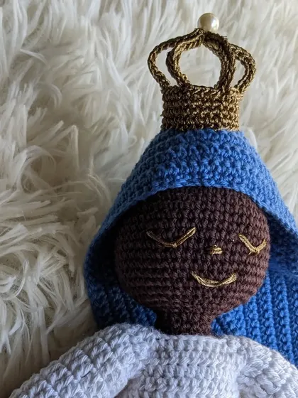A close-up of the custom Mother Mary doll, focusing on the details of her crown and peaceful expression.