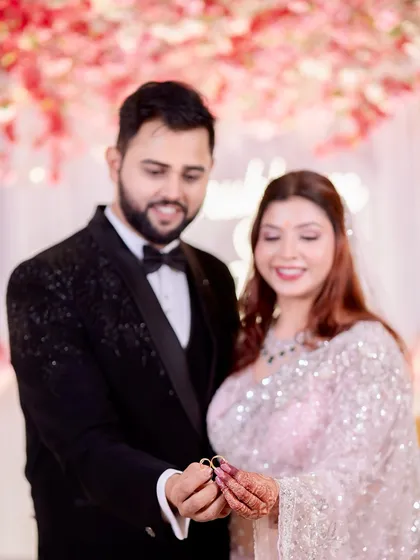 A happy, candid moment as the couple proudly displays their engagement rings. It's a joyful photo that marks the beginning of their journey together.