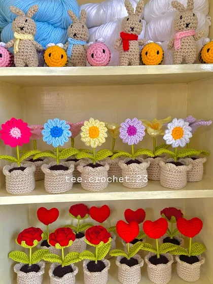 A cheerful collection of potted daisies and heart flowers, alongside some amigurumi bunnies and bees.