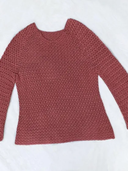 A full view of the finished Etoile Sweater, laid out to show its shape and the bell-sleeve design. Every crochet top is made to order, so we can adjust the length of the body and sleeves to your preference.