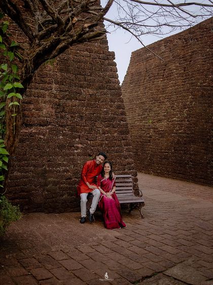A quiet moment together on a bench within the fort walls. This wide shot captures the scale and history of the location.