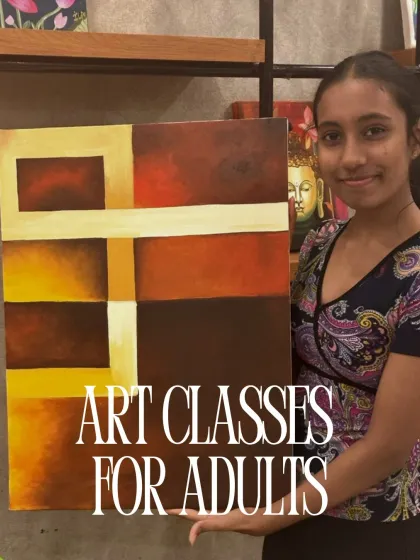 A young woman holds her abstract painting, a great example of the kind of work you can create in my art classes for adults.